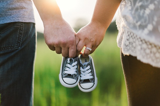 A couple with baby shoes.