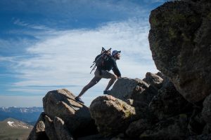a man hiking on the rocks