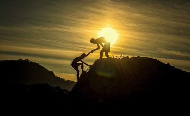 Friends climbing a mountain.