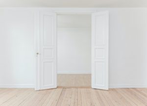 An opened door in an empty room