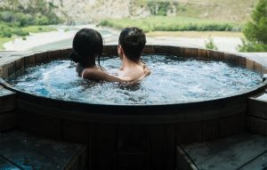 A couple enjoying in a hot tub. 
