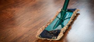 a mop cleaning the wooden floor