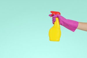 a woman holding a cleaning product