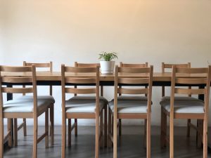 Prepare your dining table set for moving that has twelve chairs