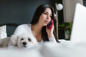 woman talking on the phone and her dog