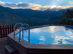 An outdoor hot tub with a beautiful sunset view.