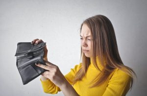 a girl holding an empty wallet
