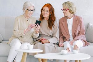 three women looking at the phone