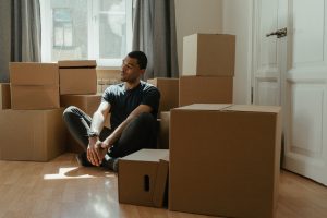 a person relaxing among boxes