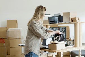 woman looking at snickers she wants to leave behind when packing for a move
