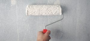 painting wall with paint roller