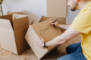 A man using quality boxes to avoid kitchen moving disasters