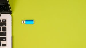 usb and laptop on yellow background