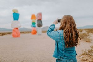 woman in blue denim jacket taking pictures
