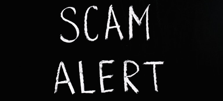 Scam alert written in white on a black background;