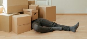 Man buried under cardboard boxes