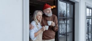 Elderly couple holding coffee mugs