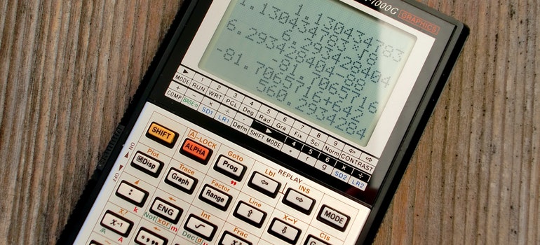 Scientific calculator on a wooden table;