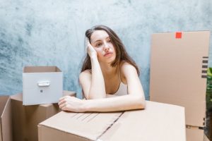 a woman thinking about how to leave a moving review after your relocation