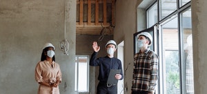 A group of people inspecting a house