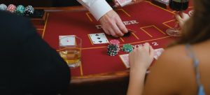 Person Dealing Cards on a Poker Table.