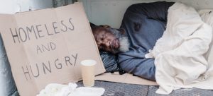 Homeless man with a cardboard sign 