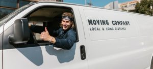 a mover showing thumbs up after packing everything safely in the moving van