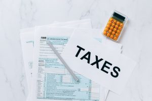 Paper with taxes you need to know more about before moving your business abroad