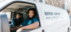 two men from a moving company sitting in a van preparing to relocate a bunk bed