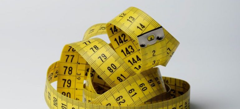 a close-up photo of a measuring tape for moving a bath tub