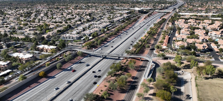 Highway with moving vehicles captured from above, among them a van owned by interstate moving companies las vegas 