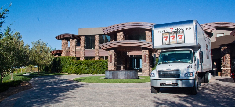 A house and a moving truck from one of the best residential moving companies Las Vegas in front of it