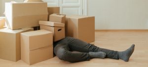 A man under moving boxes