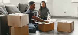 couple packing for moving after they got best deals on moving supplies in Las Vegas