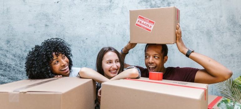 Some of the movers working for residential moving companies Las Vegas offers hiding behind the boxes